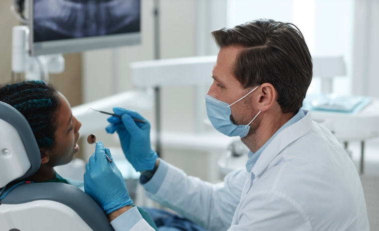 A dentist beside the patient